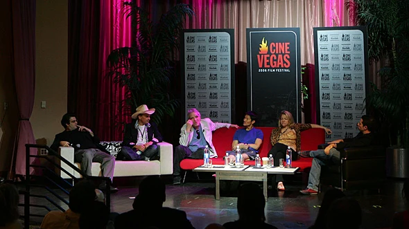 Six panelists sit on a festival stage framed by CineVegas signs and press backdrops.