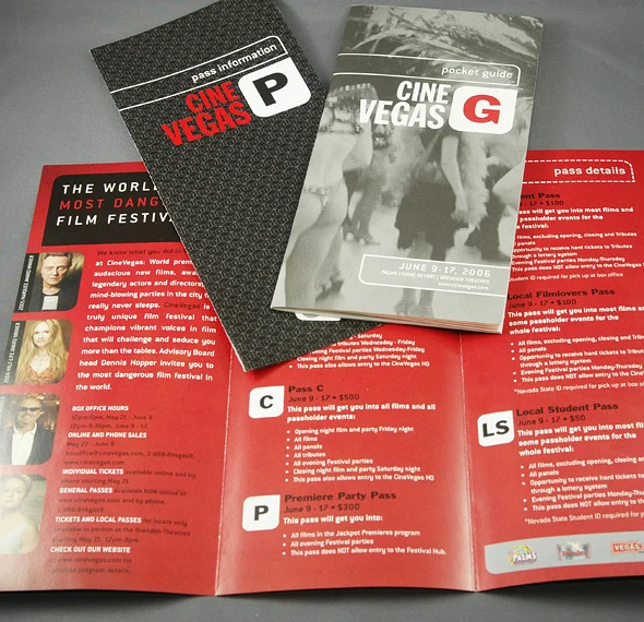 The CineVegas pocket guide and pass information materials arranged over an open red brochure.