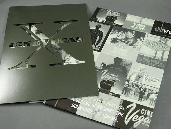 A metallic CineVegas X folder with a die-cut cover arranged beside a printed retrospective of the festival's first decade.